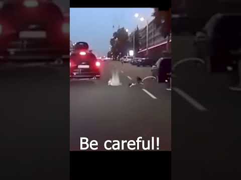 Never open a car door without looking around! Thank God the cyclist is alive!