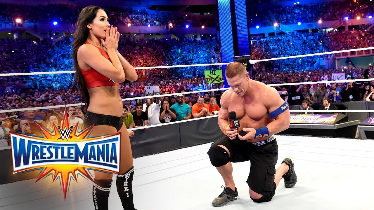 Image result for John Cena gets down on one knee and proposes to his girlfriend Nikki Bella in front of 70,000 fans at WrestleMania