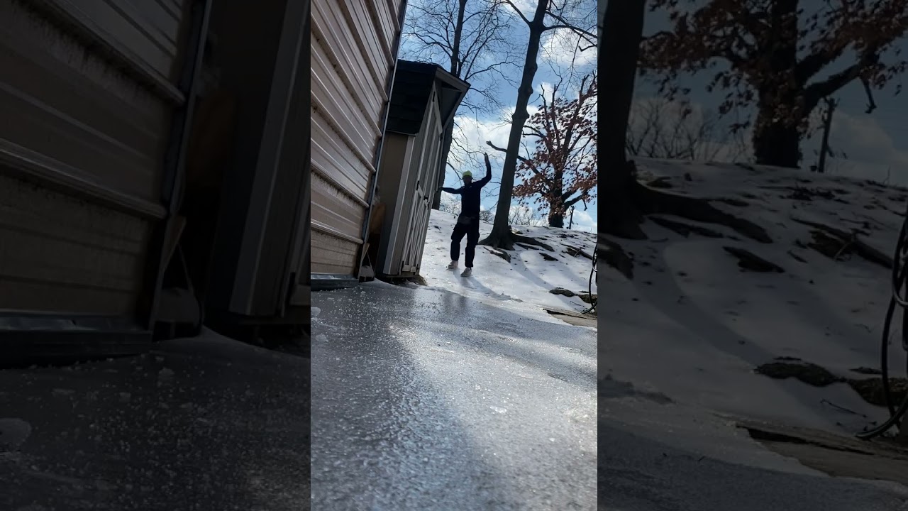 Guy slides down sheet of ice on his feet and faceplants