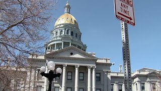 Anti-migrant signs attached to parking posts outside Colorado State Capitol