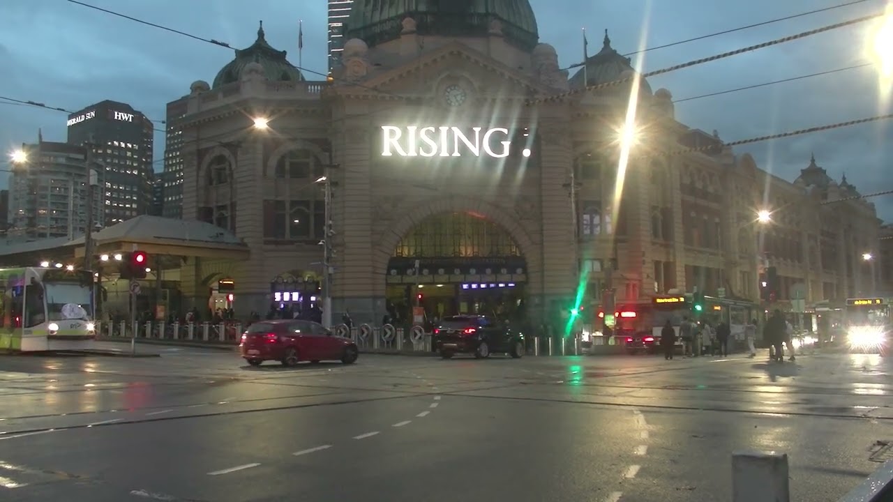 Tram passing Flinders St  Rising: Display at Flinders St Station