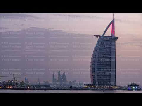 Dubai skyline with Burj Al Arab hotel day to night timelapse.