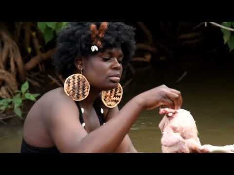 African girl slaughtering chicken barefoot