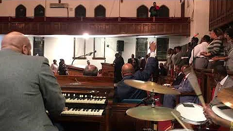 Pastor Michael Lampkin sings "I'm Saved" . . . She...