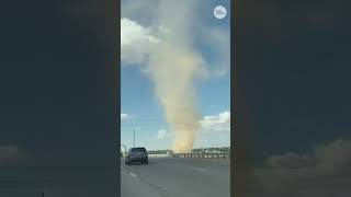 Massive dust devil spins beside Texas highway. See the video.