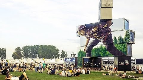 artists paint stacks of shipping containers for north west walls