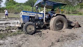 swaraj 744 XT tractor stuck in the mud and driver trying to take out