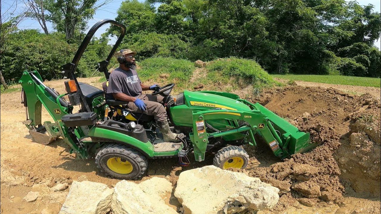 John Deere 1025r 260b Backhoe Pallet Forks Move Last Of Rock Youtube