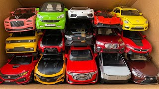 Box full of model Cars, Beetle, Rolls Royce, Mini EV, Jaguar, BMW, Camaro, Civic.
