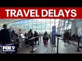 Post-holiday travelers navigating delays, cancellations