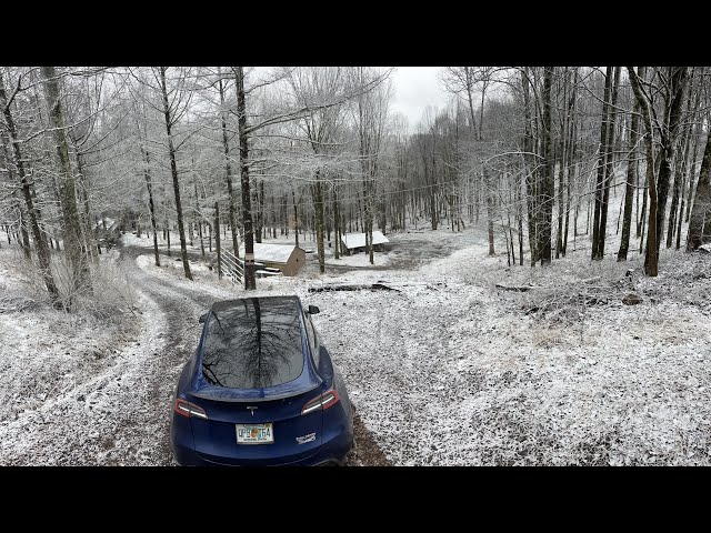 Tesla model Y in off-road assist during a snow storm up a 23% grade 