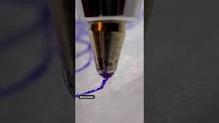 The ball of a pen loosing ink while rolling over paper.