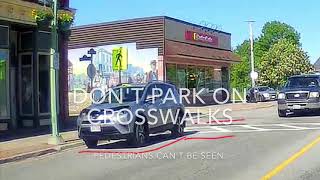 Another car parked in crosswalk blocking view of pedestrian