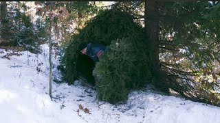 Building a shelter in the winter in the forest to survive.