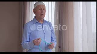 An Old Man with Rosary Beads Praying | Stock Footage - Envato elements