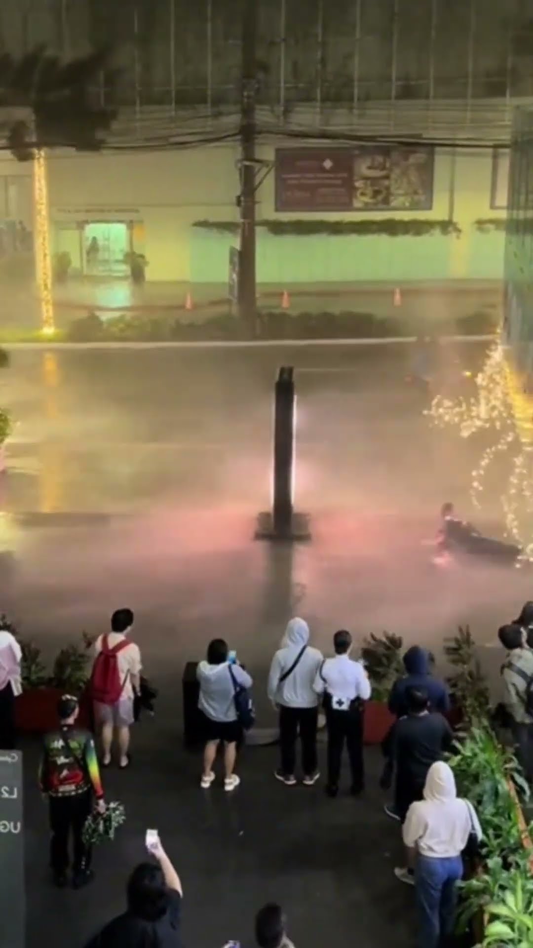 Two People Slip on a Sidewalk During a Windy Storm