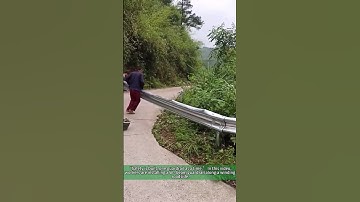 Workers Installing W - Beam Guardrail: Road Safety Upgrade