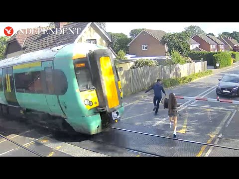 'Reckless' pedestrians seconds away from being hit by train in terrifying level crossing CCTV