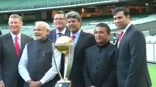 PM Modi, Aus PM Tony Abbot pose with Cricket World Cup Trophy at MCG