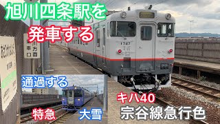 旭川四条駅を発車するキハ40宗谷線急行色と通過するキハ183系特急大雪