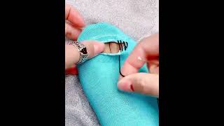 Sew a tear in a sock with a needle and thread