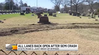 Semi crashes through guardrail into cemetery on State Road 2