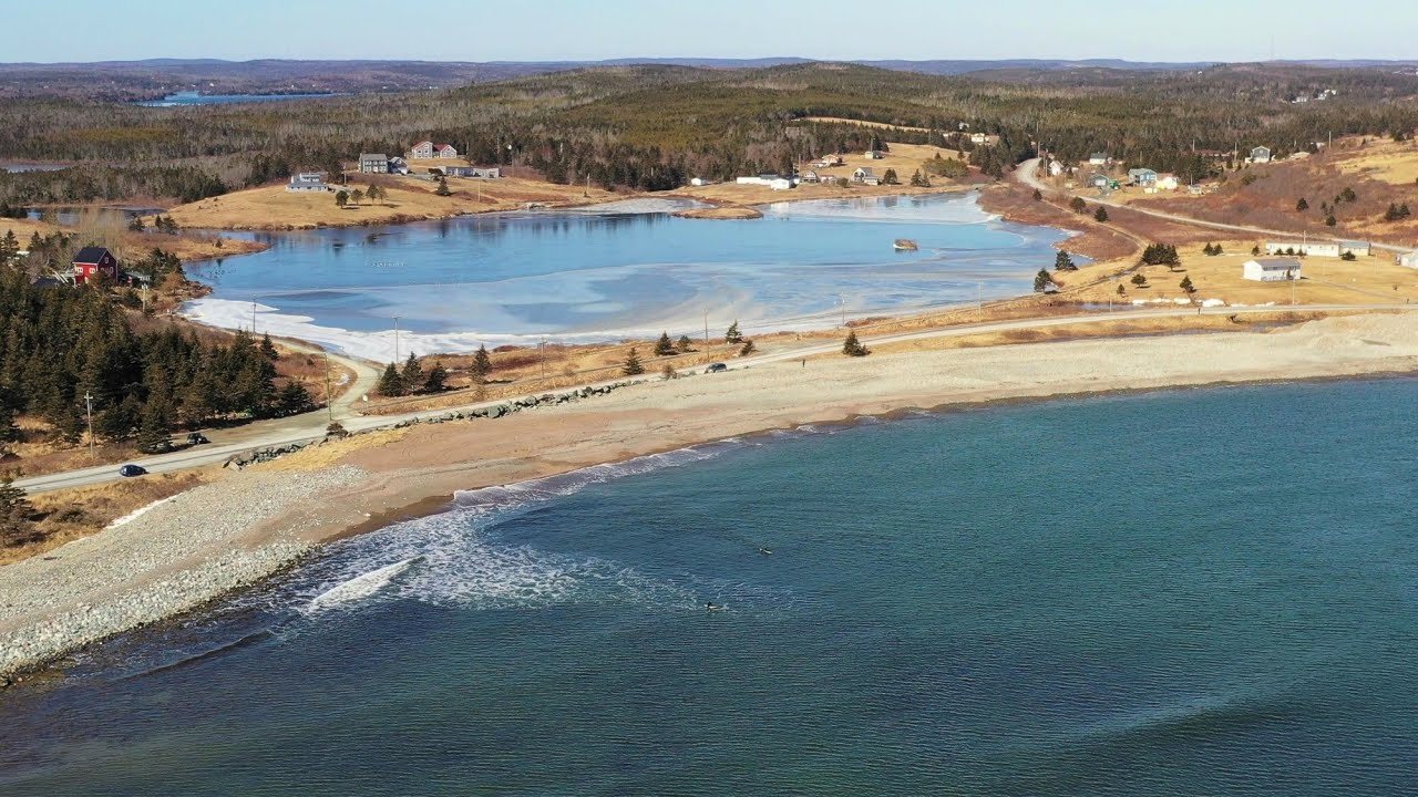 Beautiful Ice and Sunny Beach with Surfers at Seaforth, Nova Scotia