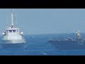 Watch as the US Navy fires warning shots toward an Iranian patrol boat