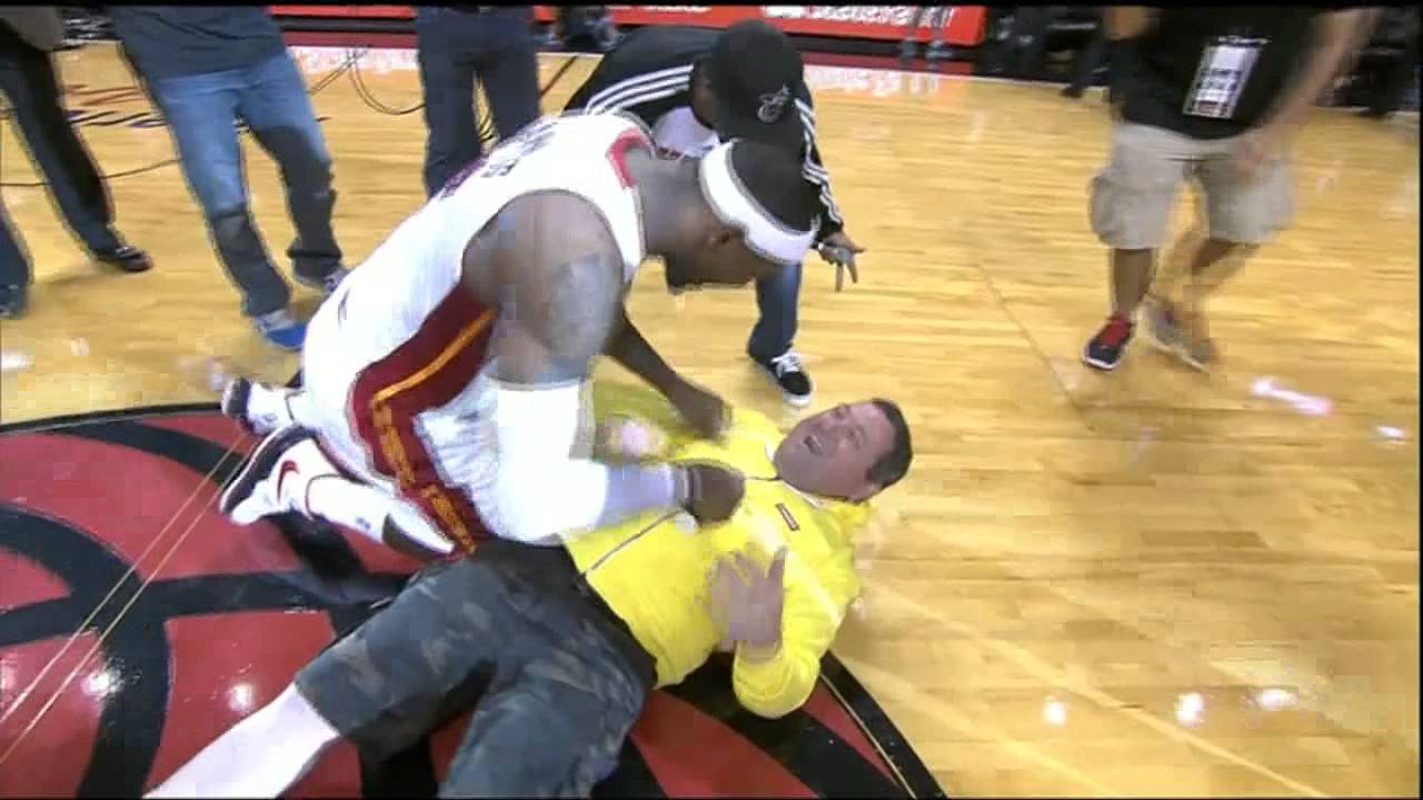 VIDEO: Heat fan hits $75,000 halfcourt shot, LeBron tackles him - CBSSports.com
