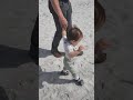 Happy cute baby first time on the beach
