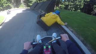 Guy crashes into girl riding luge cart then another girl crashes into them