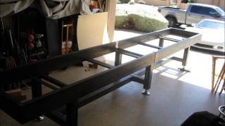 Custom shuffleboard table made from salvaged bowling alley wood and shuffleboard cradle made of steel and powdercoated.