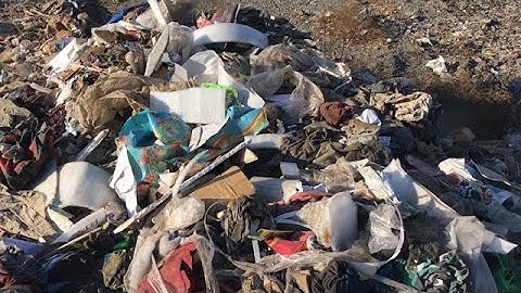 Pile of garbage at dump ground polluting environment | stock footage | stock video | Cinefootage