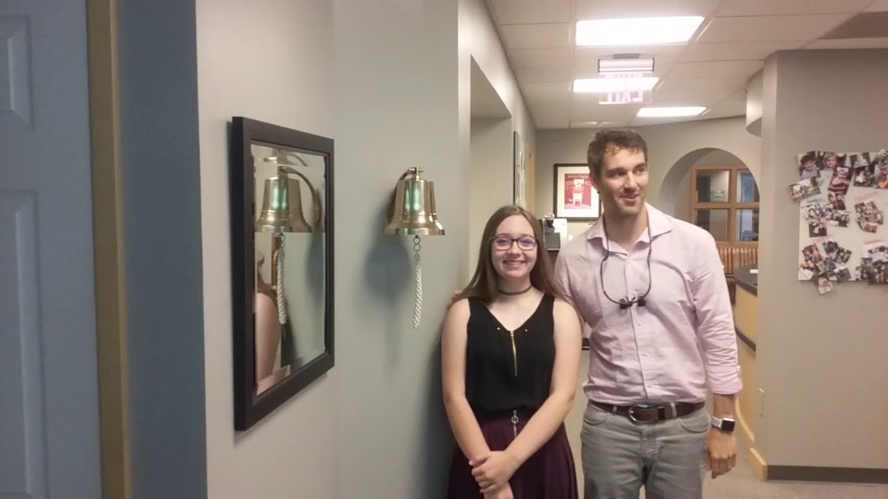 Emily ringing the bell after getting her braces removed.