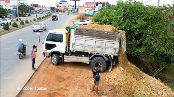 Awesome dump truck unloading soil landfilling with skill operator bulldozer working push stone fill