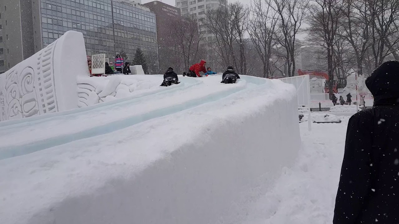 2018 Sapporo Snow Festival. Nippon cup noodle Slide and a boy.