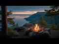 Sunset Over The Valley Campfire Glowing Above A Quiet River Landscape Below