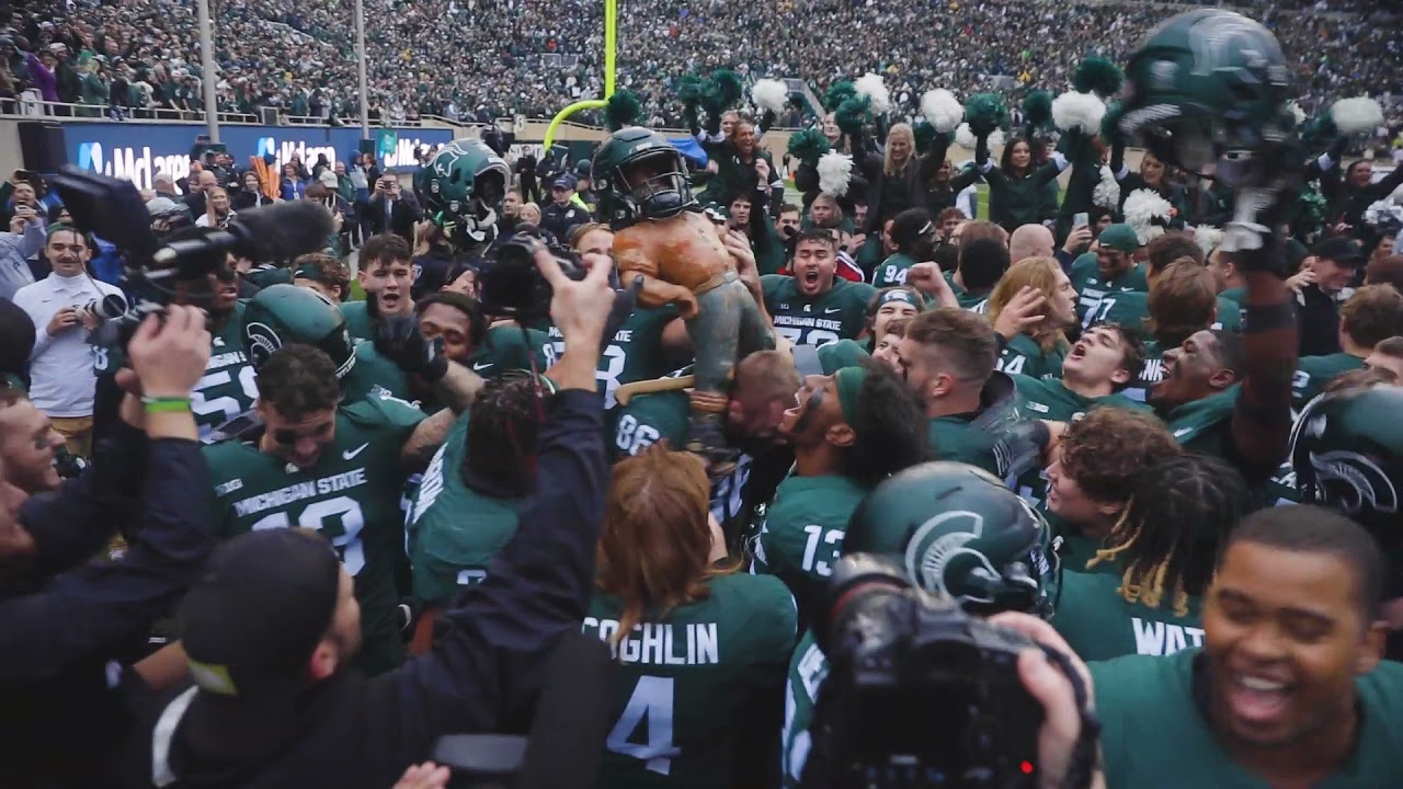 Michigan State Spartans celebrate with Paul Bunyan trophy