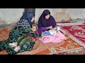 A nomadic woman helps remove the babys throat