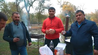 Camping and delicious barbecue of chicken, lamb and hashlama in a cauldron on a fire