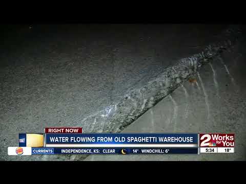 Water gushing out of old Spaghetti Warehouse and turning into ice