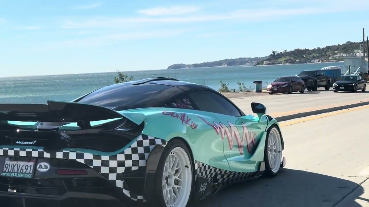 Vintage Porsche takes photos of new McLaren on Pacific Coast Highway Malibu California 