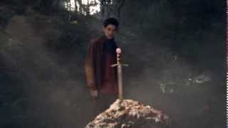 Merlin places excalibur into the stone