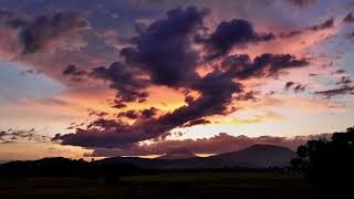 Sky Symphony: Aerial Hyperlapse of Majestic Clouds and Fiery Sunset - Captivating HD Video