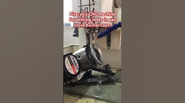 Five-axis CNC machine for drilling holes in gas stove burner caps. #cncdrillingmachine #cnc