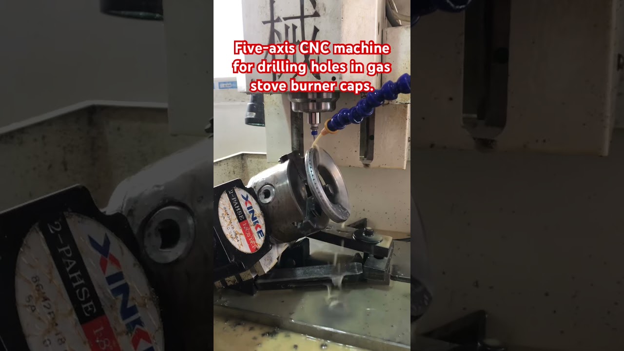 Five-axis CNC machine for drilling holes in gas stove burner caps. 