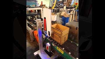 iCON Laser Coder prints text on corrugated cases removing preprinted ink on boxes