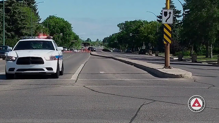 You drive along a street and hear a siren. you cannot immediately see
