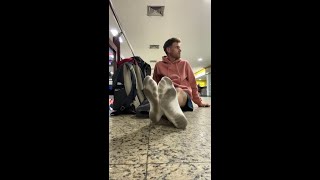 Walking Through A Crowded Bus Station In White Socks