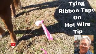 Tying Ribbon Tape on Hot Wire Fence. Simple Tip to keep them from sliding on wire.